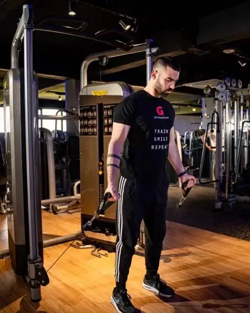 Προπονητής καθοδηγεί μέλος σε personal training
